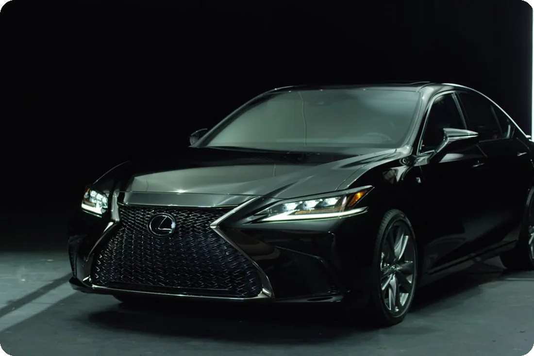 Dark studio vehicle shoot focused on automotive design, lighting, and product detail