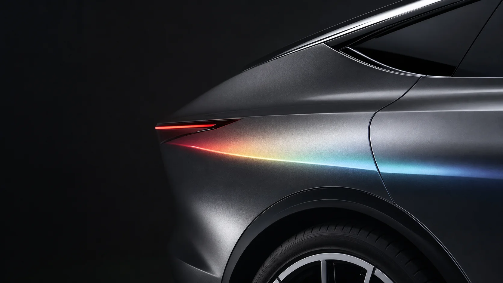 Close view of an unbranded vehicle body showing its rear light, wheel arch, material finish, and precise panel transitions