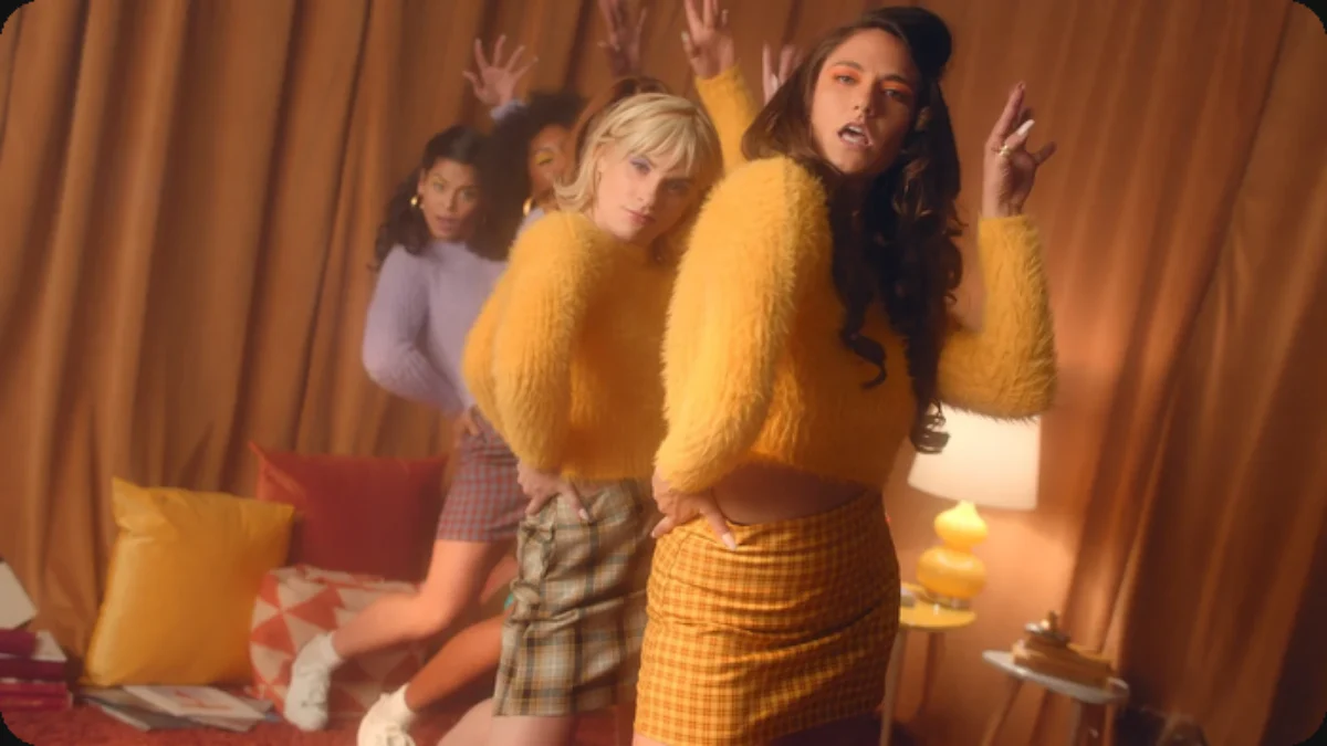 Color-led campaign scene with three people arranged in a warm interior