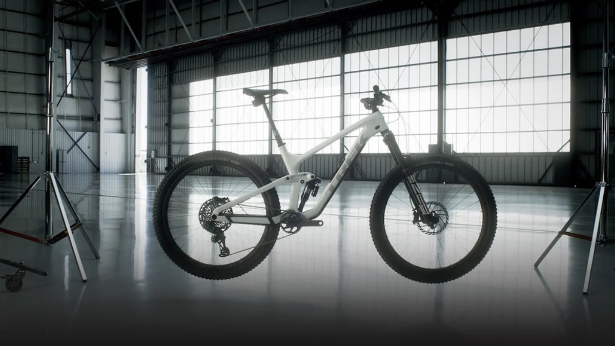 Computer-generated product image of a bicycle suspended in an industrial studio