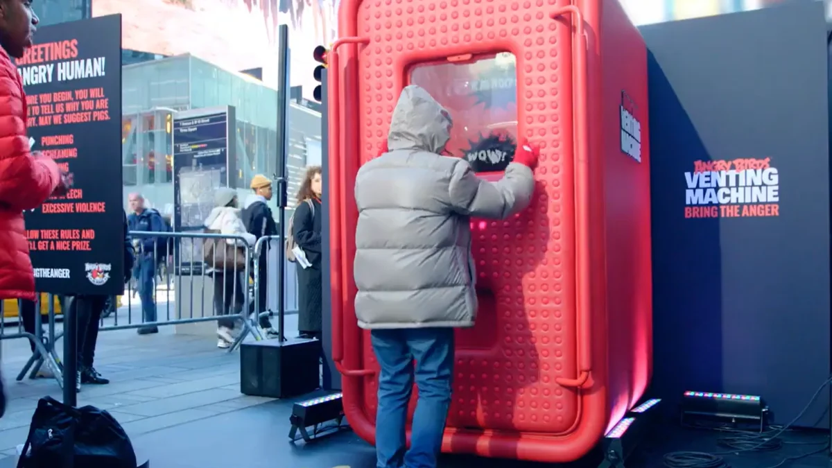 Person interacting with a large physical installation in a public event environment